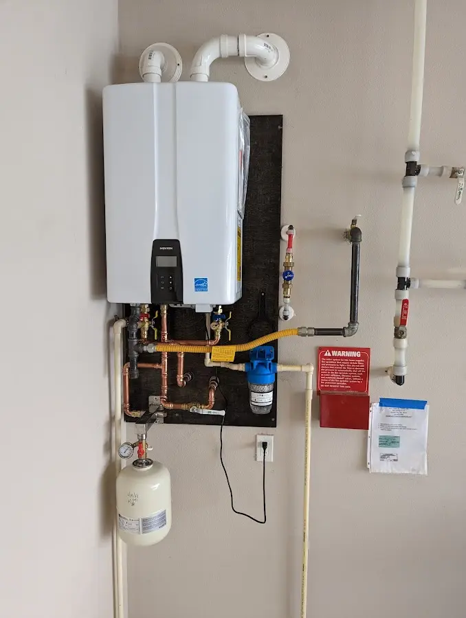 Professional plumber installing copper piping in a Tustin home